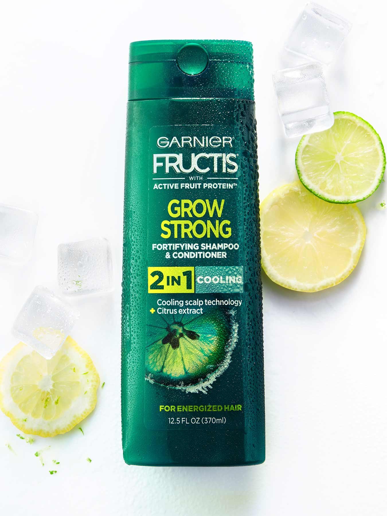 Cooling 2-In-1 Shampoo and Conditioner for Men on a white background with ice and lemon and lime slices.